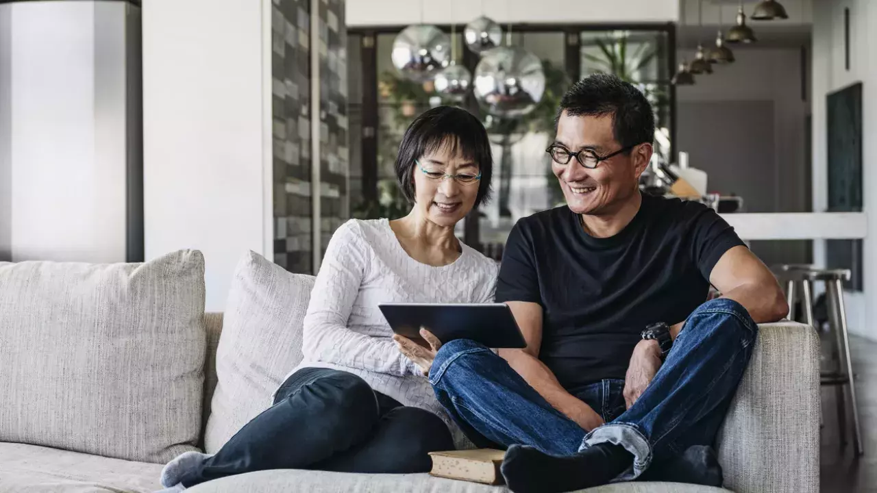 couple using tablet at home in living room