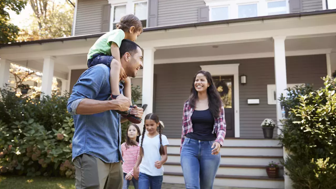 Young family walking out of their house