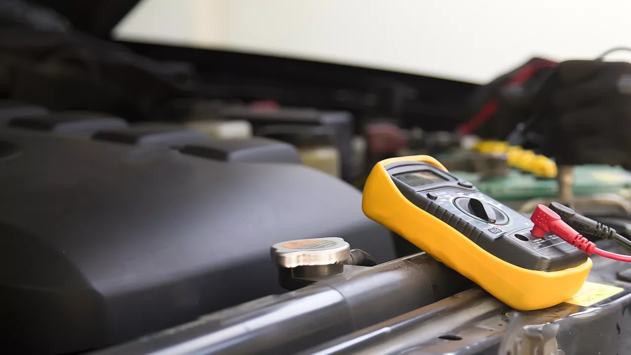 Technician checking the battery of the car