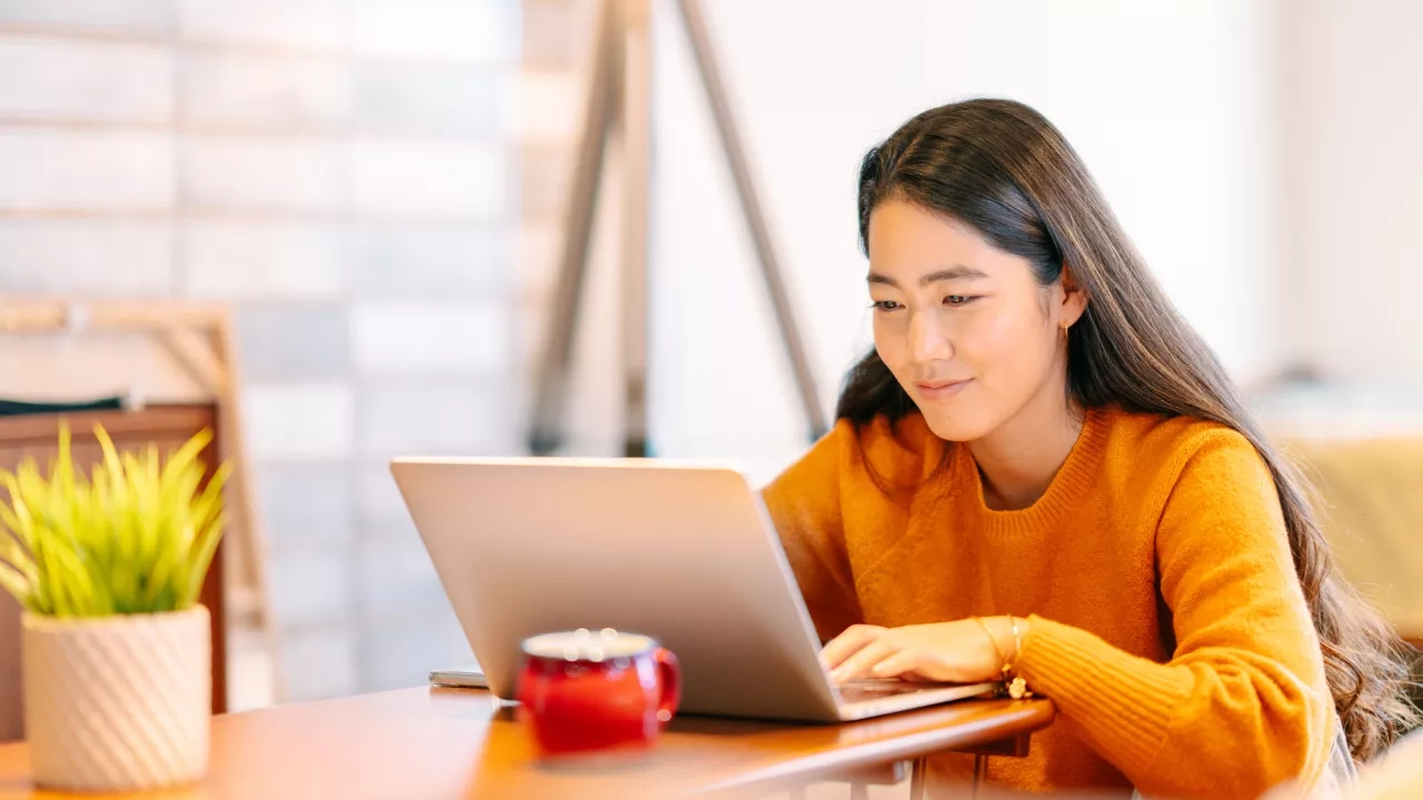 Young woman using laptop at home