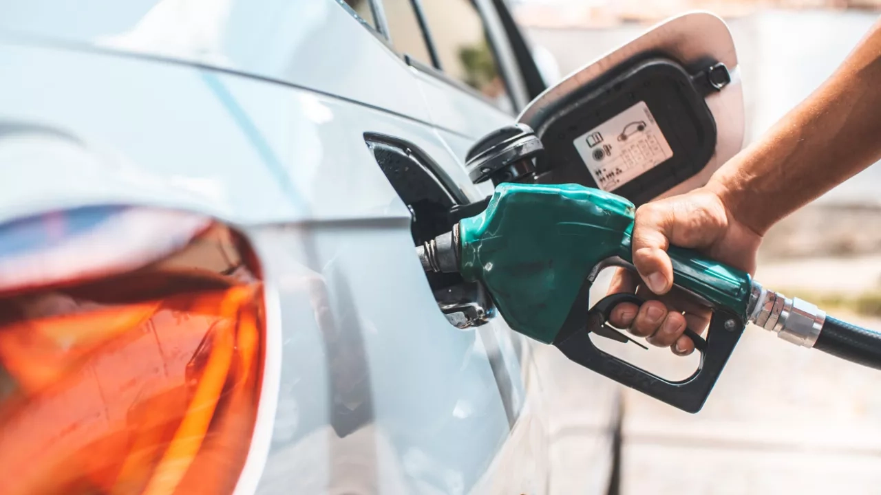 Person fueling up their car with gas