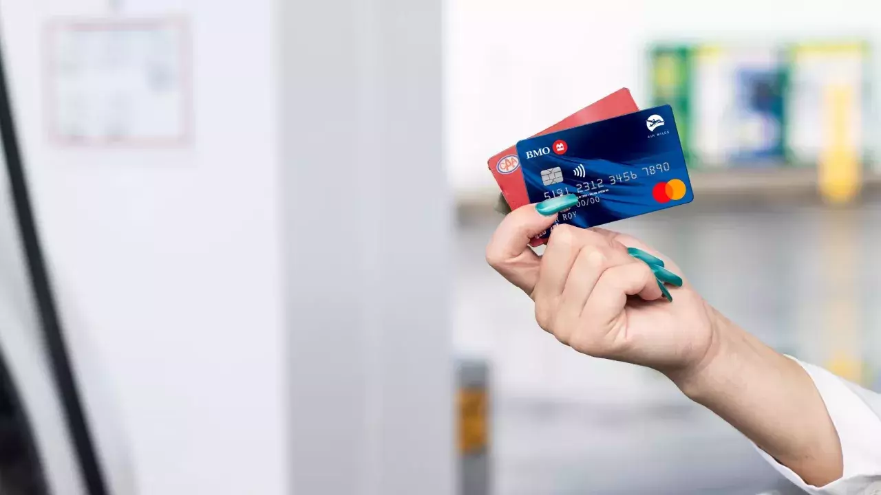 Person holding a BMO credit card at a Shell station