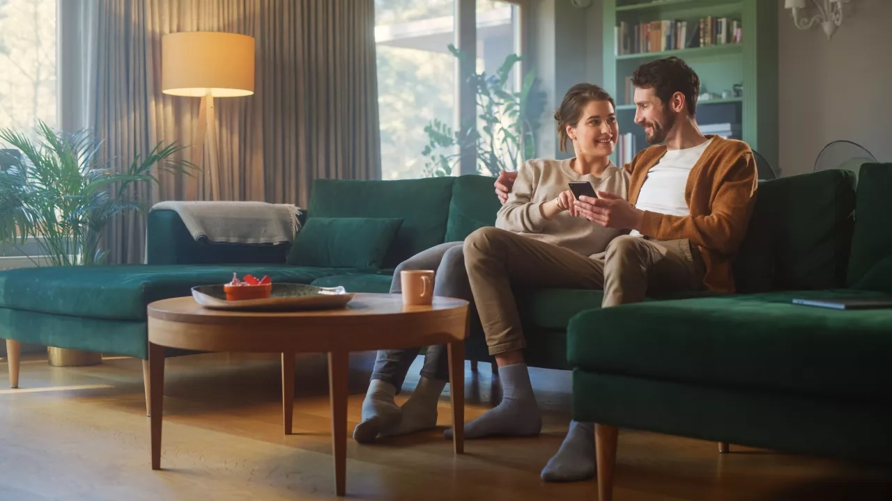 couple-using-a-smartphone-while-sitting-on-a-couch.jpg