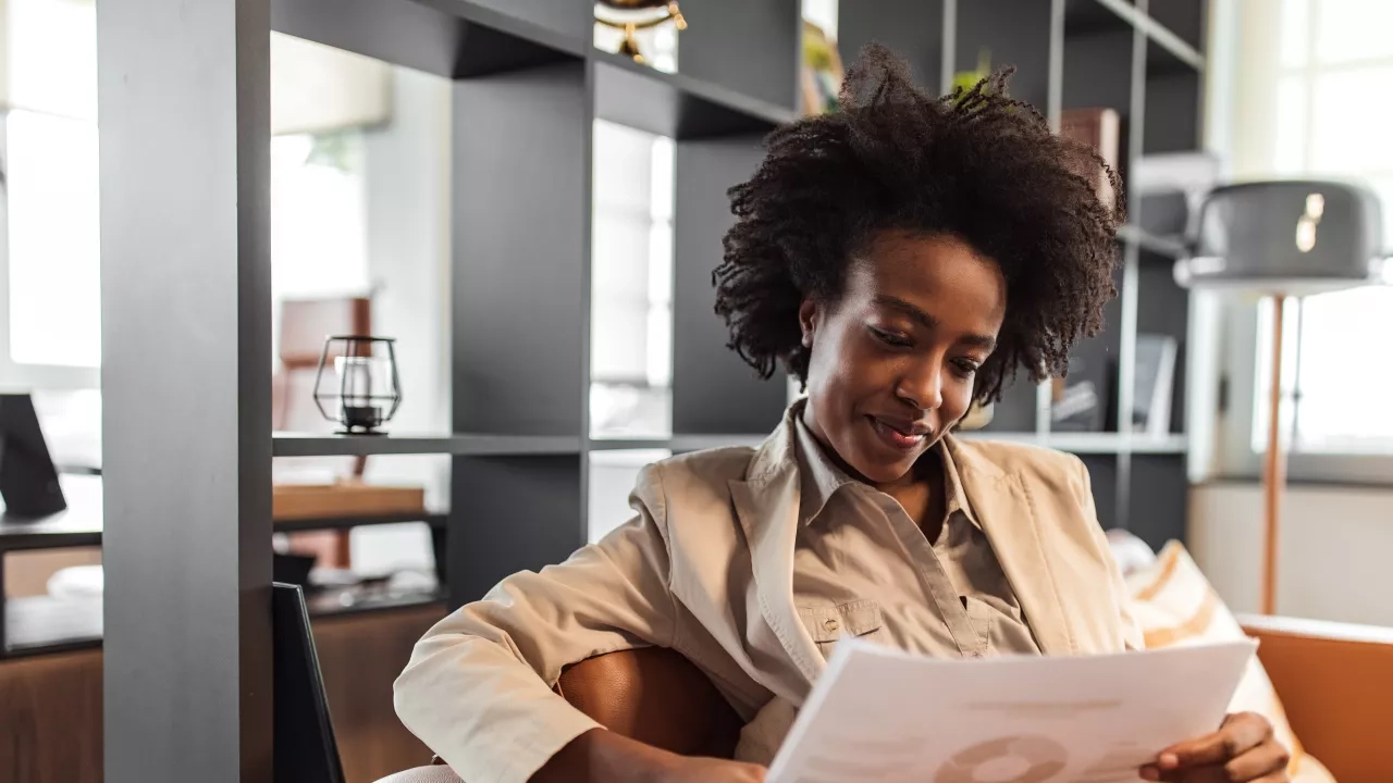 Woman sitting in office looking at papers