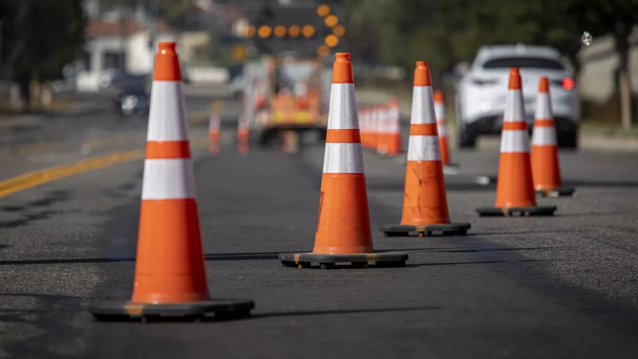 orange traffic cones on busy road