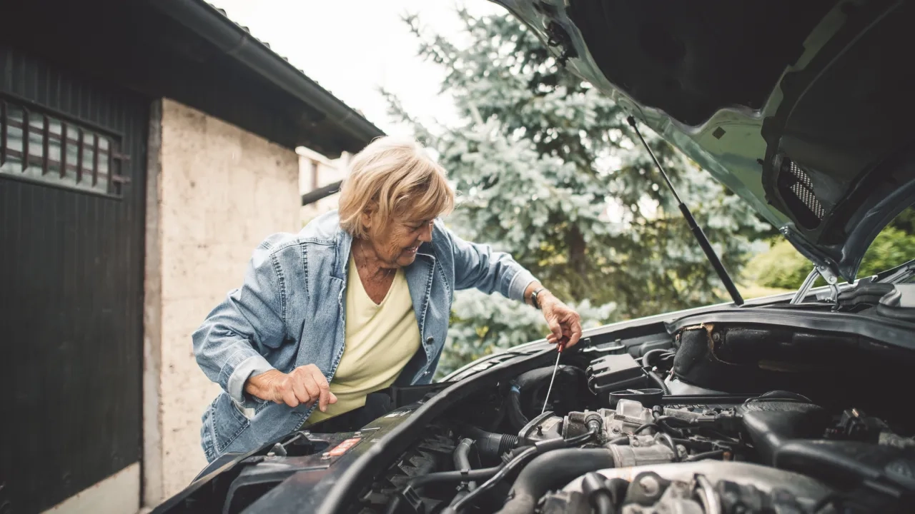 older-woman-checking-oil-level-in-car-engine