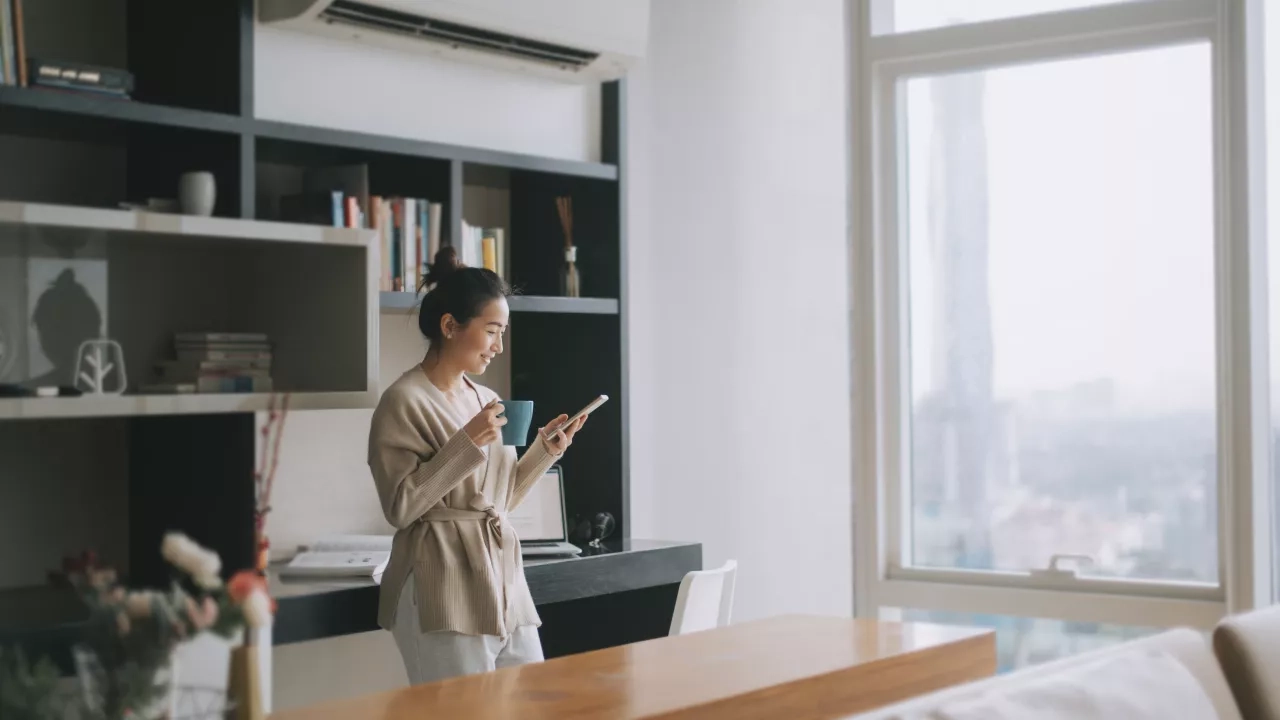 Woman standing in kitchen of condo