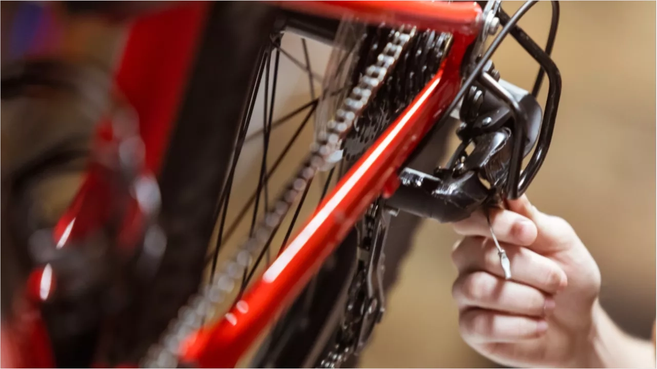 hand fixing the wheel of a bike