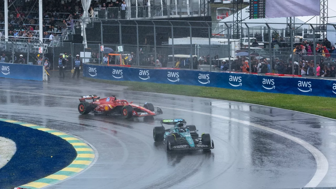 Racecars navigate the Montreal track in the rain