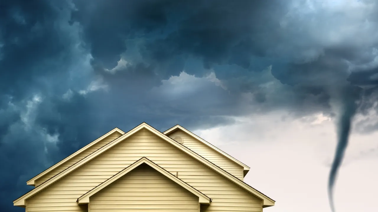 house roof with approaching tornado
