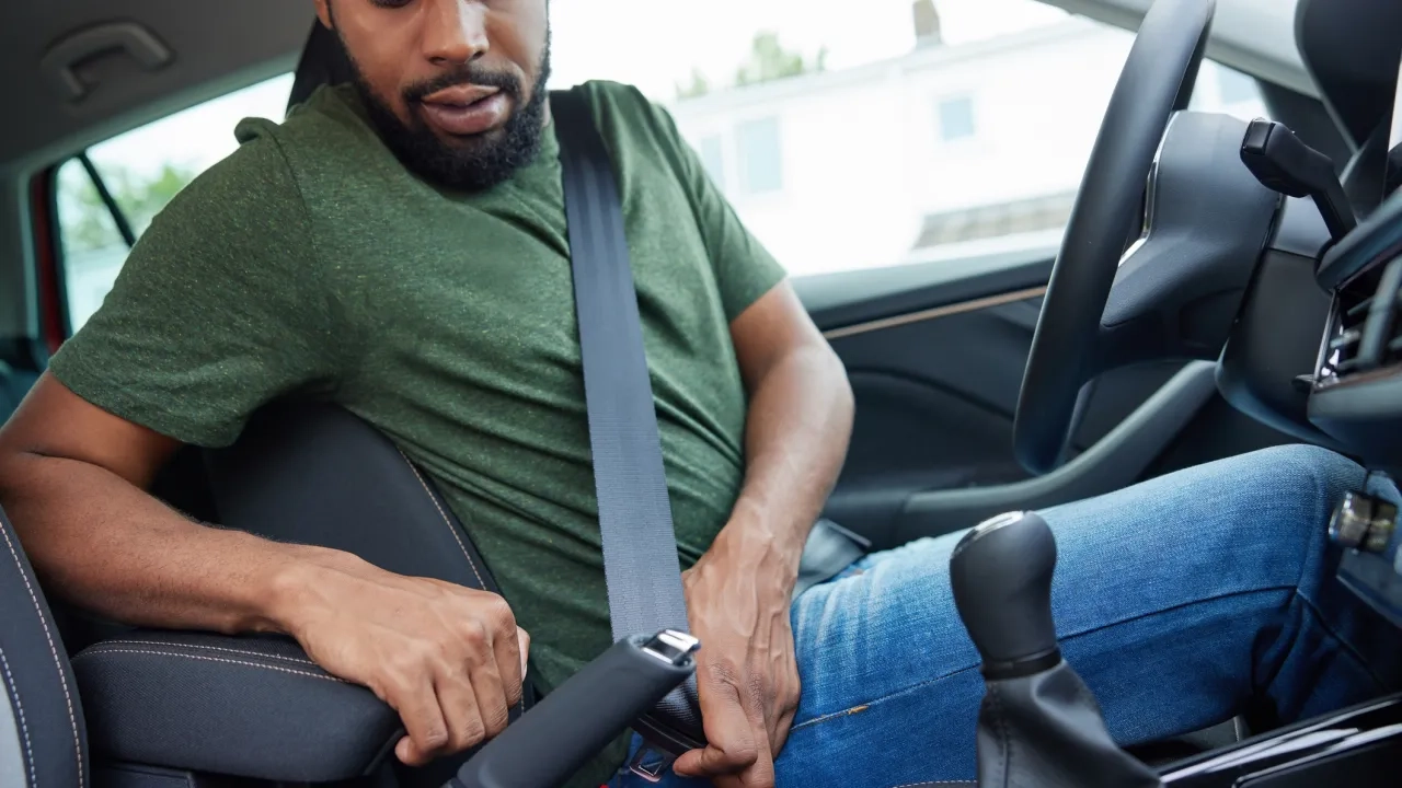 Man putting on seatbelt
