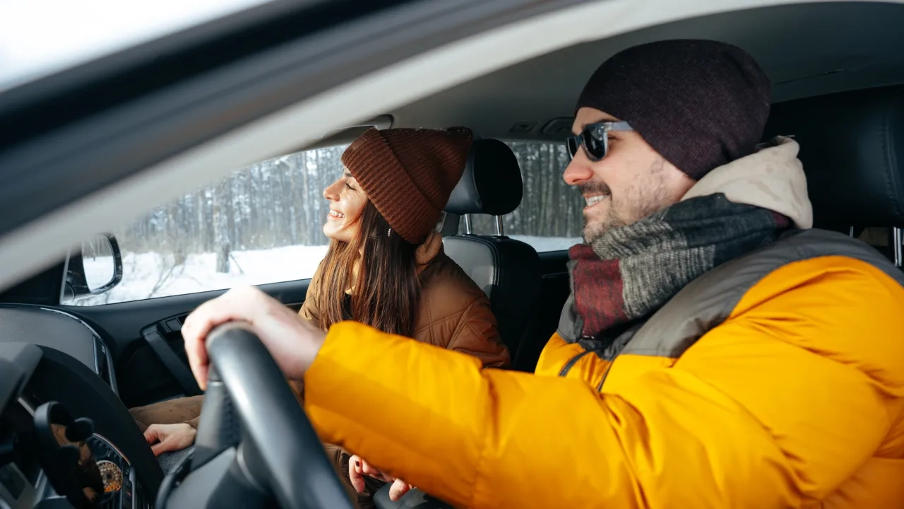 couple sitting in car in winter 