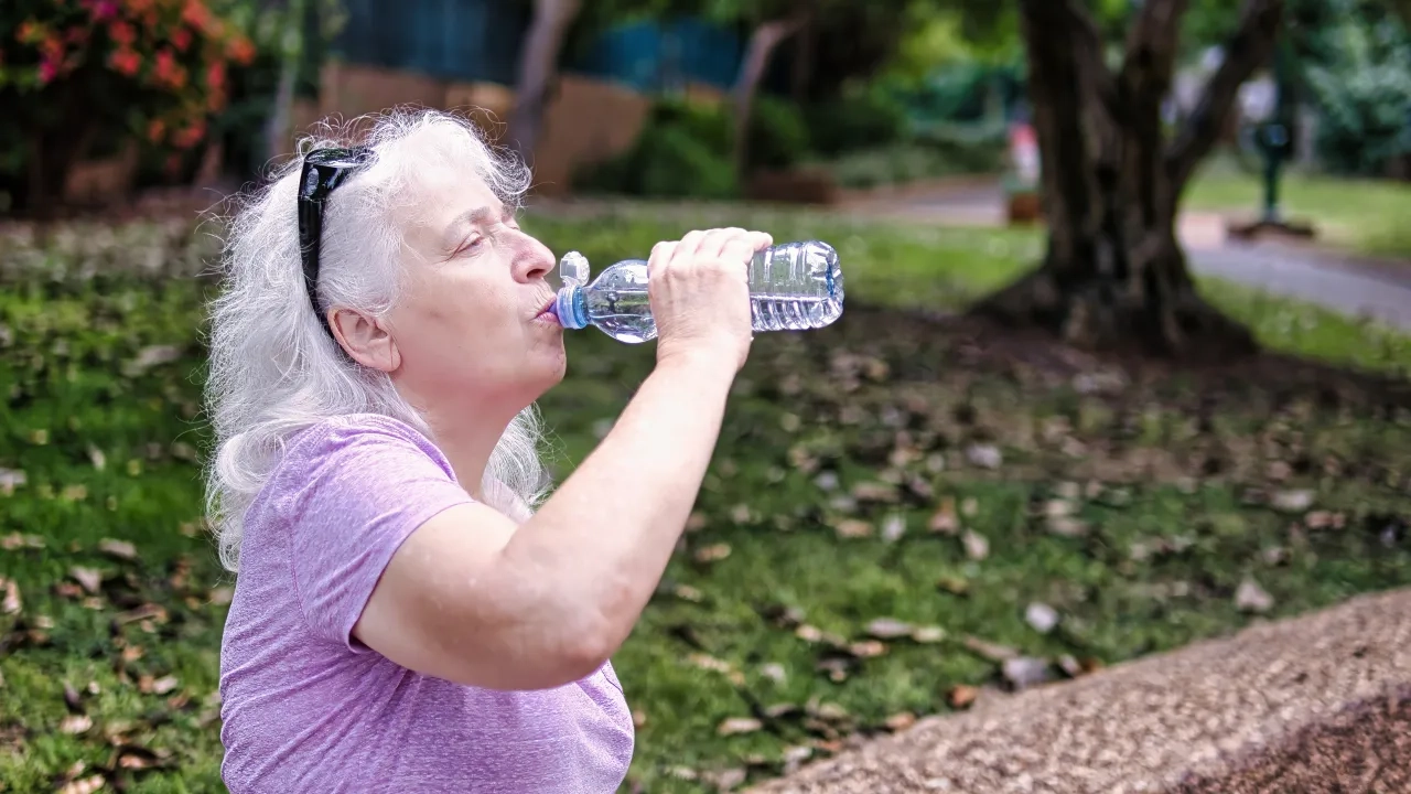 Senior woman drinking water