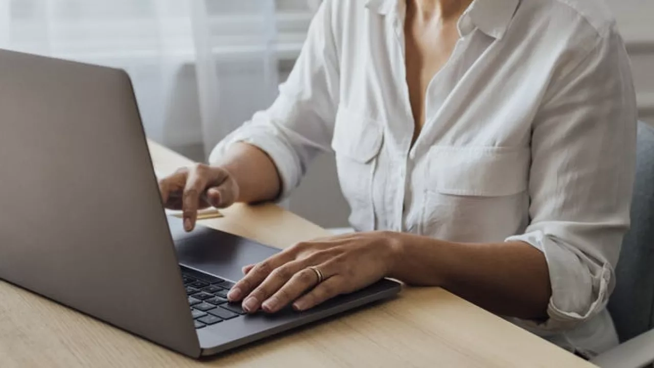 Female working on her desk with laptop