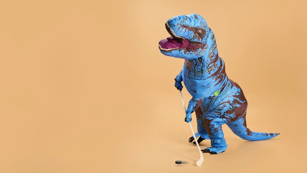 Inflatable dinosaur playing hockey
