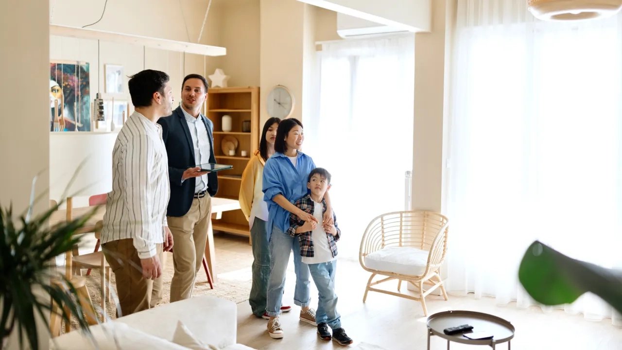 Family with young kids buying a new home with a real estate agent