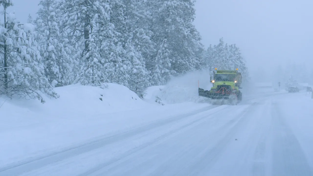 Truck plows snow on road