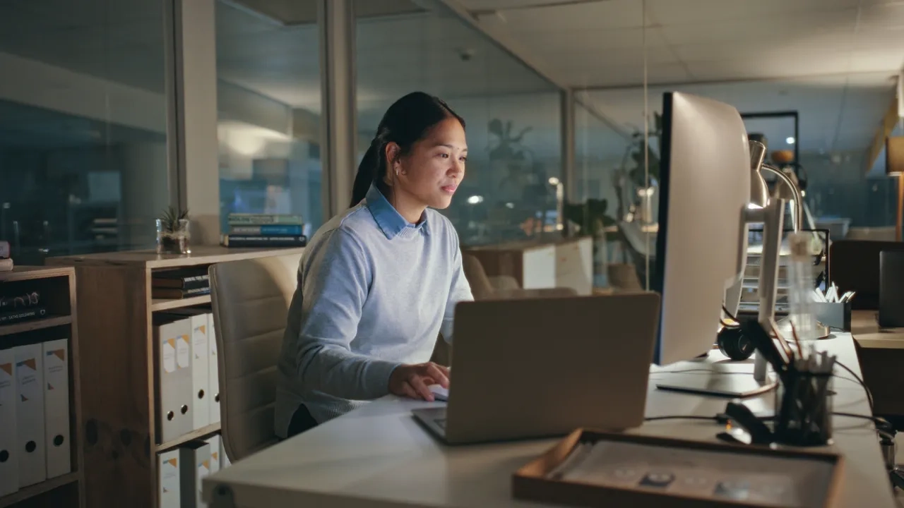 Woman working at desk with laptop