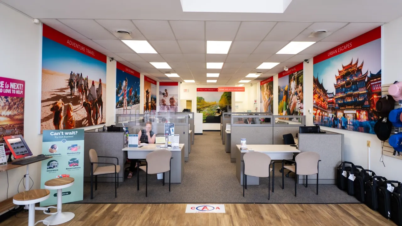 Inside CAA North Bay with desks and luggage