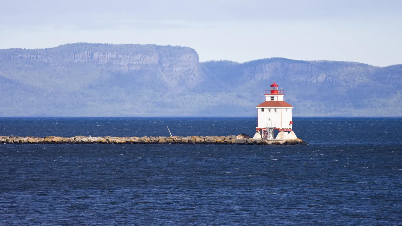 Lighthouse with rock formation in the background