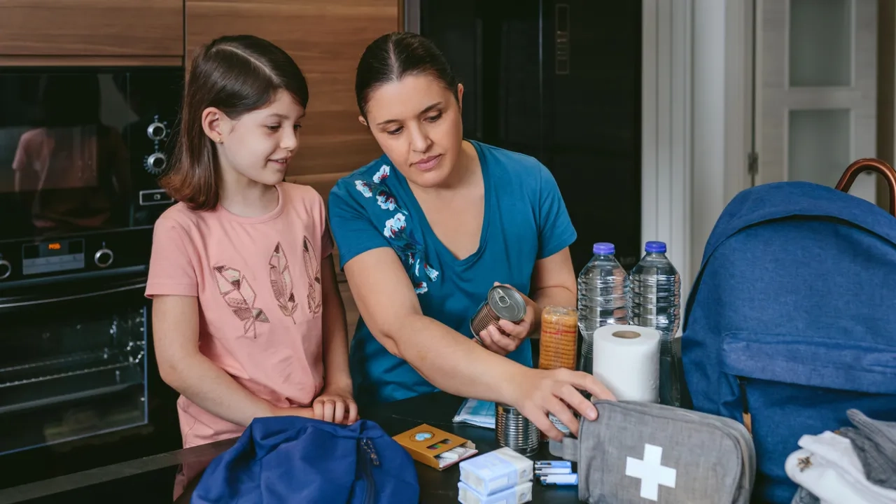 mom and daughter checking emergency kit