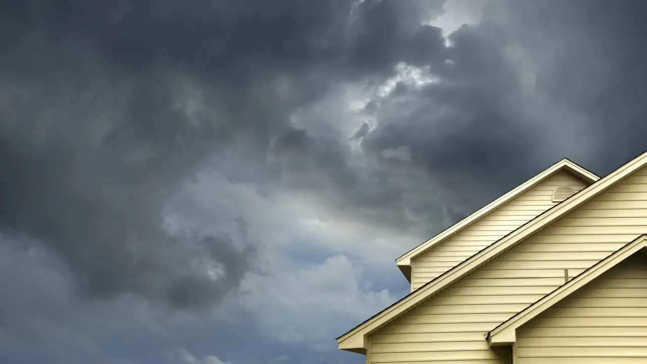 House roof with stormy skies