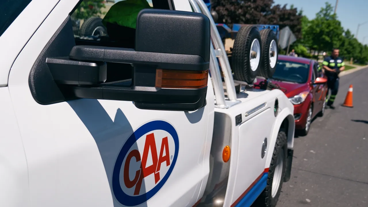 CAA tow truck on the side of the road.