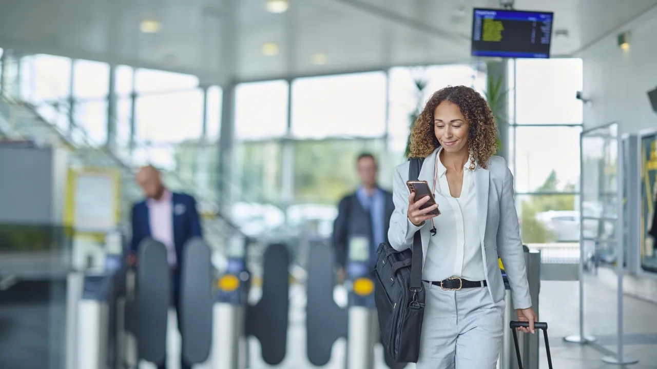 Woman in airport looking at phone