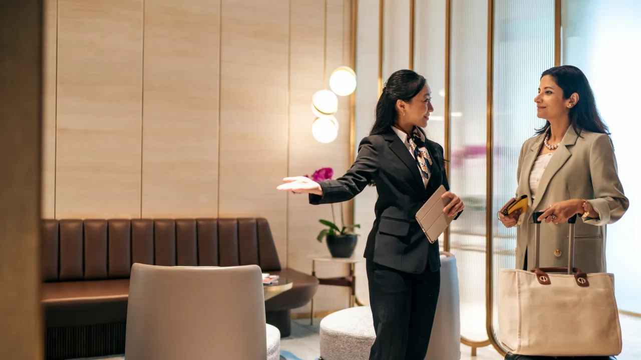 woman being escorted into airport lounge