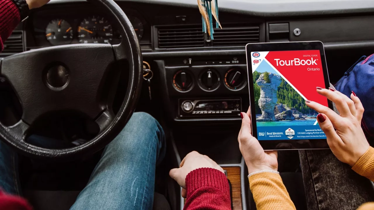 Woman viewing an Ontario TourBook on her tablet 