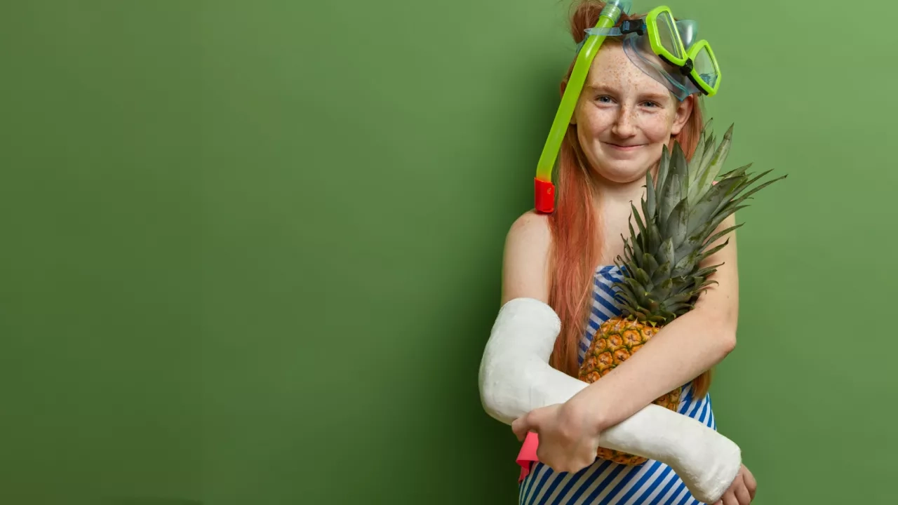 Smiling girl with a broken arm