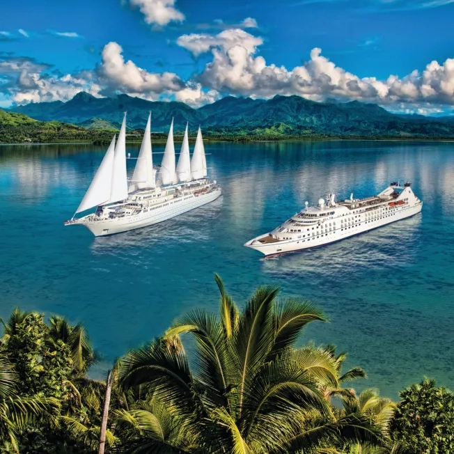 Windstar Star and Wind ships side by side in the sea.