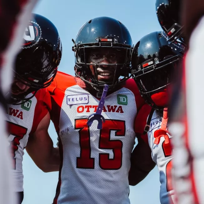 Ottawa REDBLACKS players in the huddle