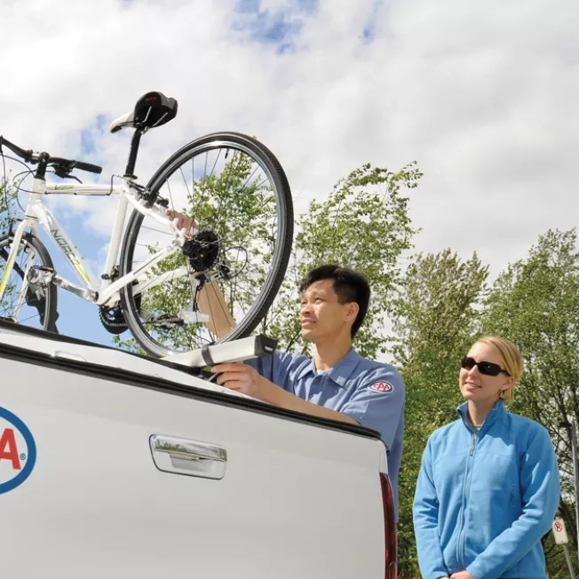 CAA roadside technician loading a bicycle onto a CAA light service truck