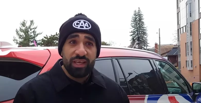a man wearing a CAA toque speaks to the camera