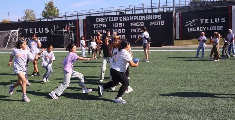 GIrls enjoy learning football skills on the field at TD Place