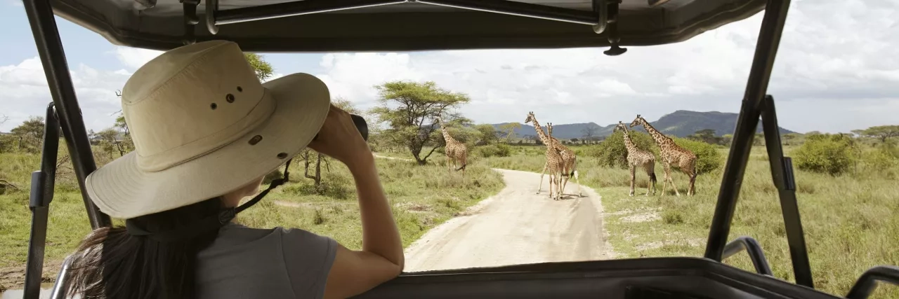 Woman riding in jeep on Africa Safari