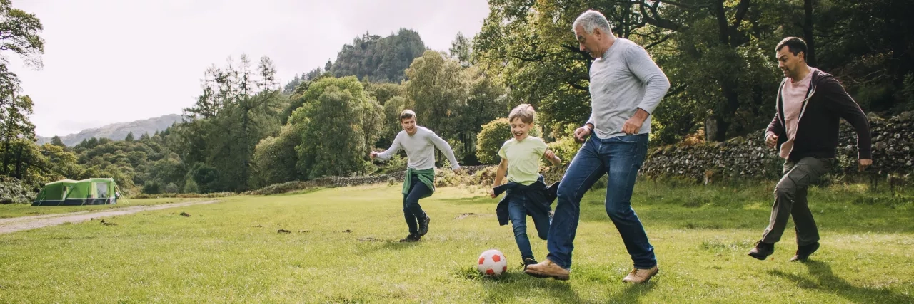 Grandpa dad and grandsons playing outdoor sports