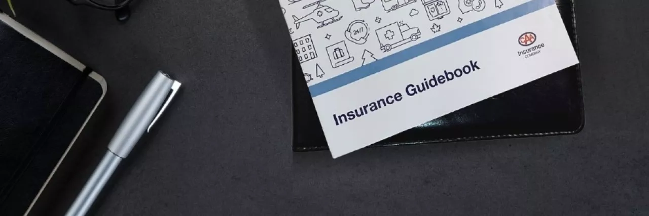 CAA insurance guidebook on desk