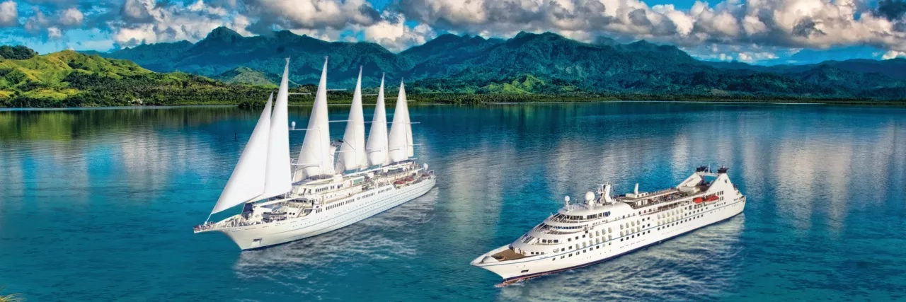 Windstar Star and Wind ships side by side in the sea.