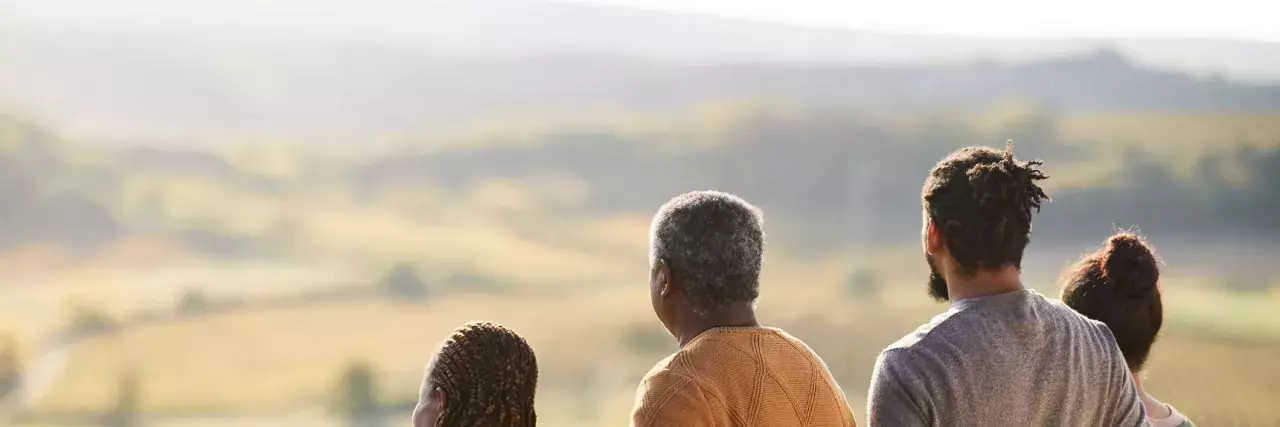 Rear view of extended family on a hill in autumn