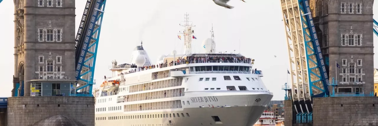 Silversea's Silver Wind ship going underneath a bridge.