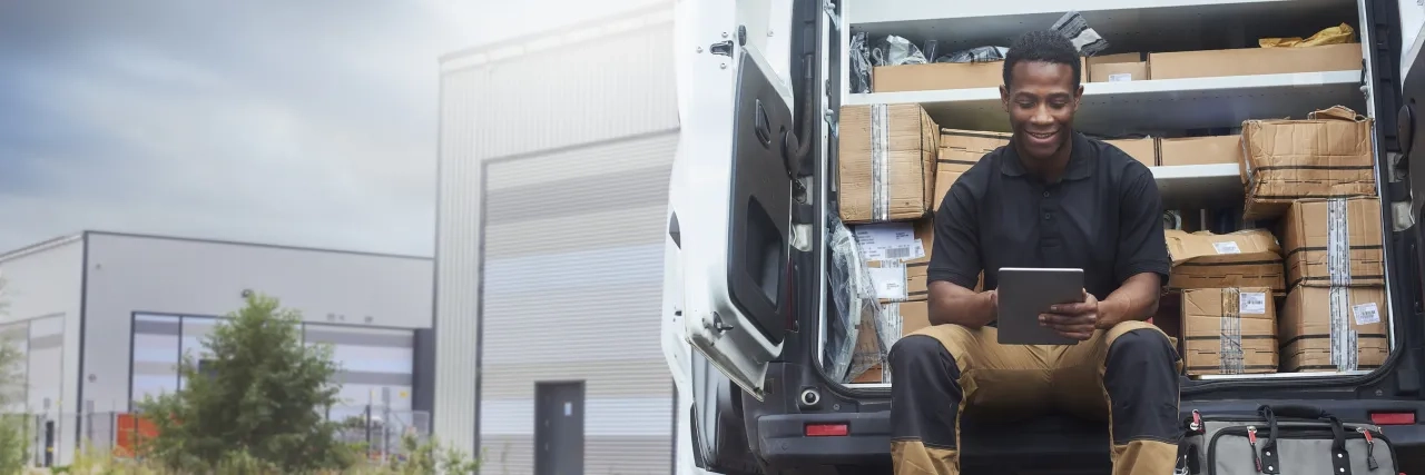 A service engineer sat at the back of his van