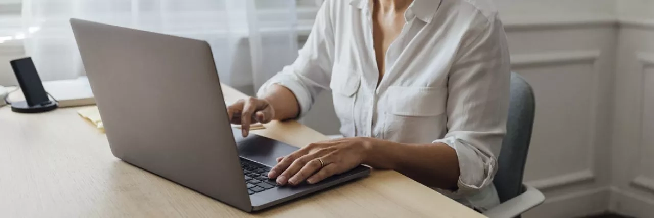 Female working on her desk with laptop