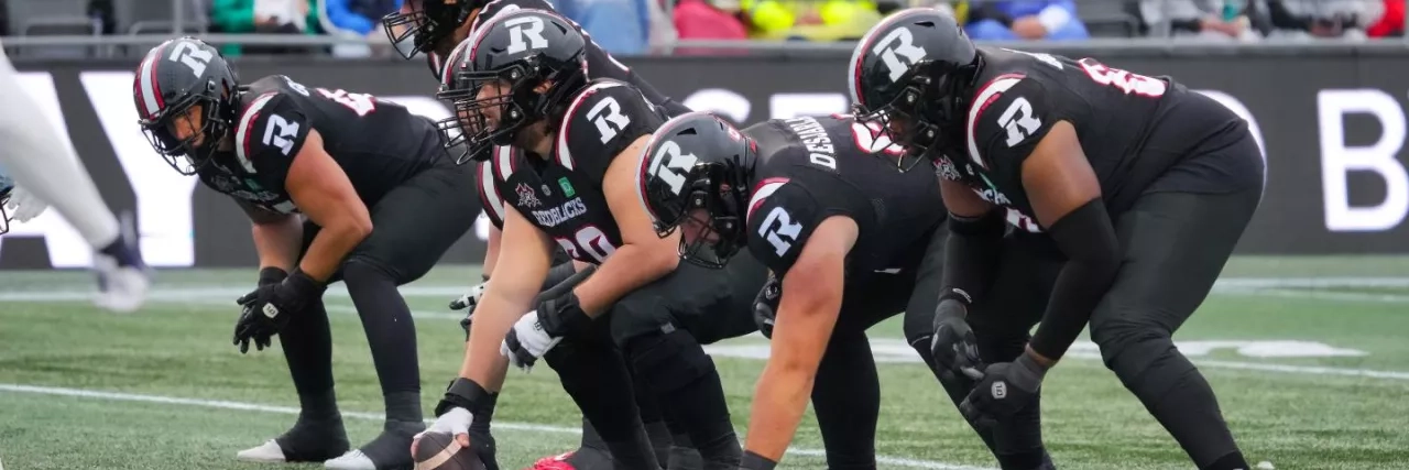 Ottawa REDBLACKS offensive line - center is about to snap the football