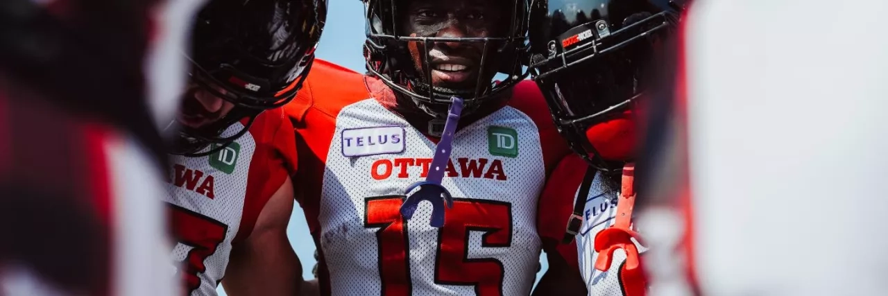 Ottawa REDBLACKS players in the huddle