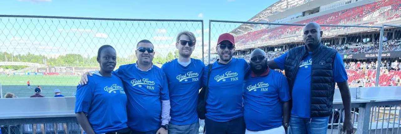 Group photo of fans at a football game