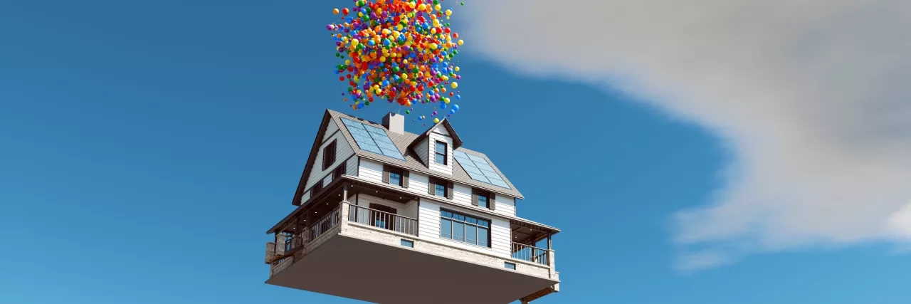 Floating house with balloons