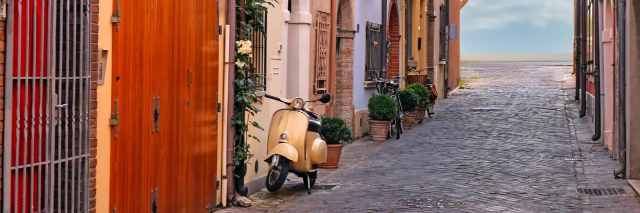 Street with scooter and old houses in Rimini Italy stock photo