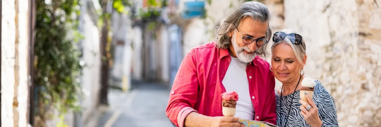man and woman with map and ice cream in hand